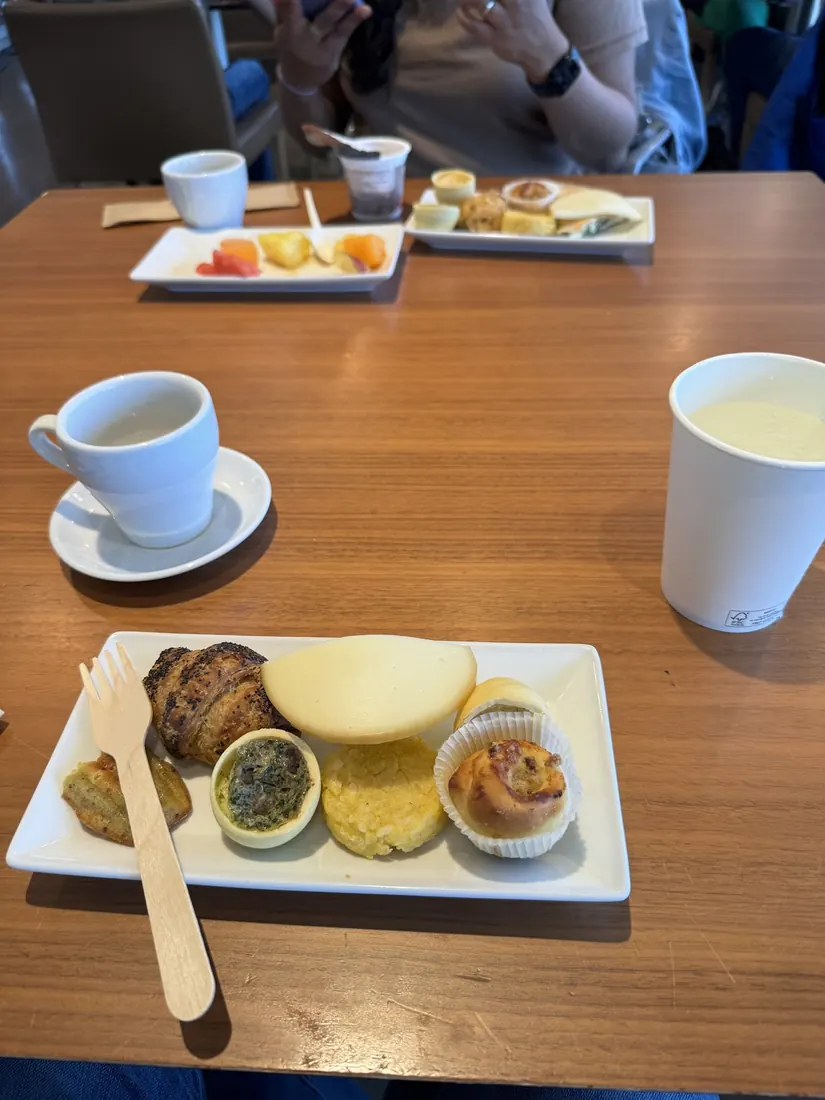 Coffee, pastries and a small soup on a tray at the airport