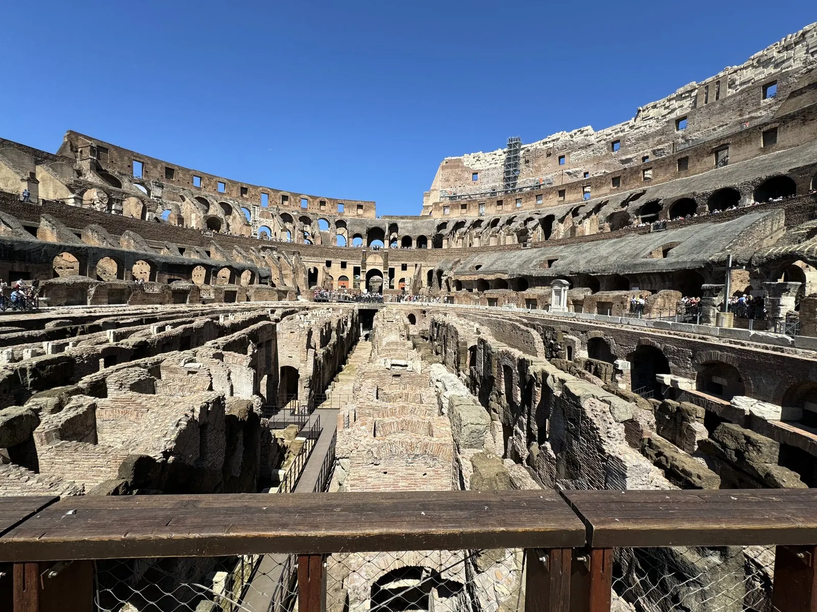 Inside the Colosseum: the exposed maze of walls and corridors under the old arena floor, the tiered stands rising behind