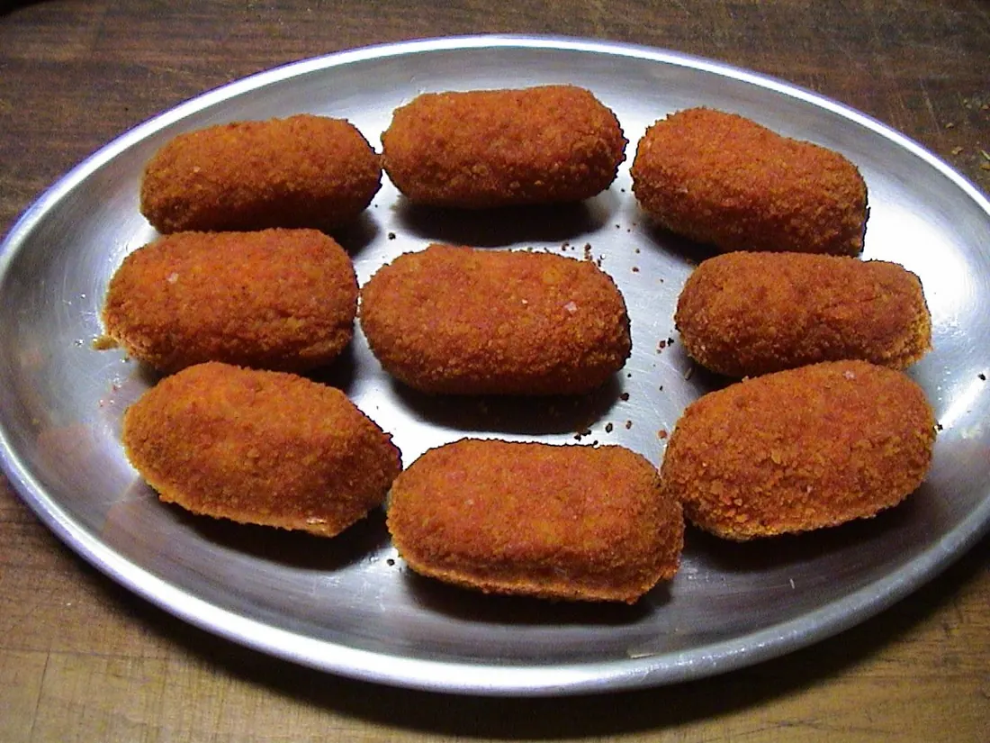 Nine supplì on an oval steel platter